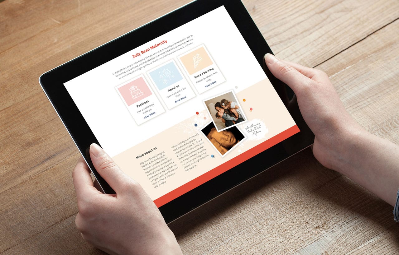 Person holding a tablet displaying a website with sections about pregnancy, birth, and baby care, along with photos and text on a wooden table background.