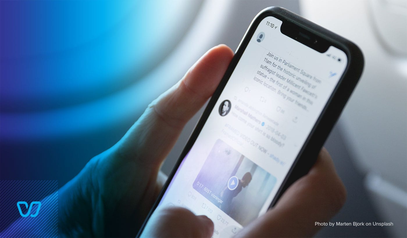 A person is holding a phone with a social media app on it.